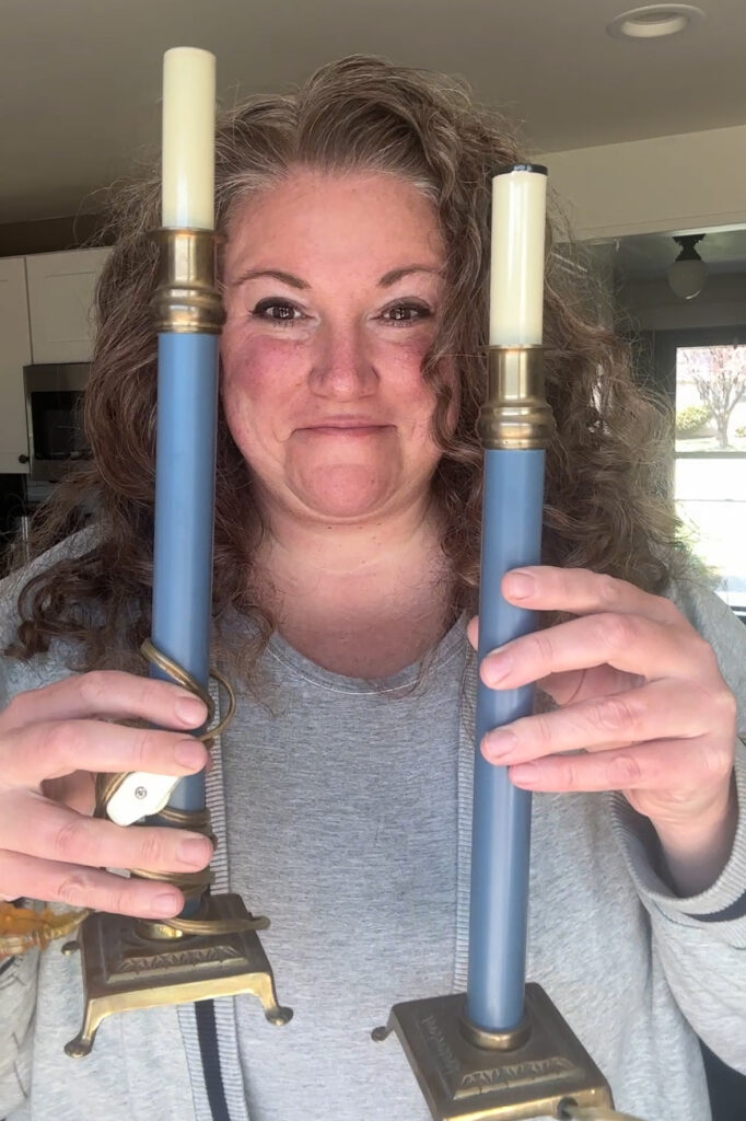 woman showing the 2 candle holder
