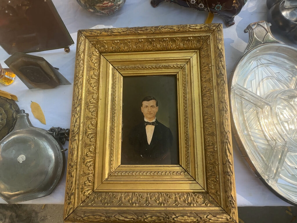 A gold-framed image of a man wearing a tuxedo, capturing a classic and refined look.
