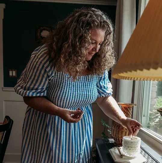 woman lighting a candle