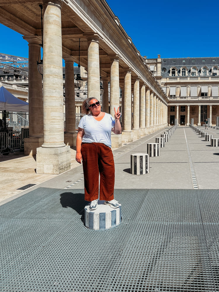 woman standing on the column in Palais Royale