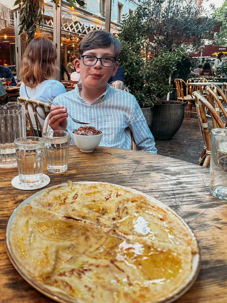 the boy is happy eating chocolate mousse