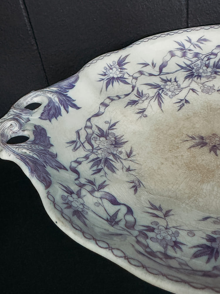 A blue and white porcelain dish featuring an intricate floral design.